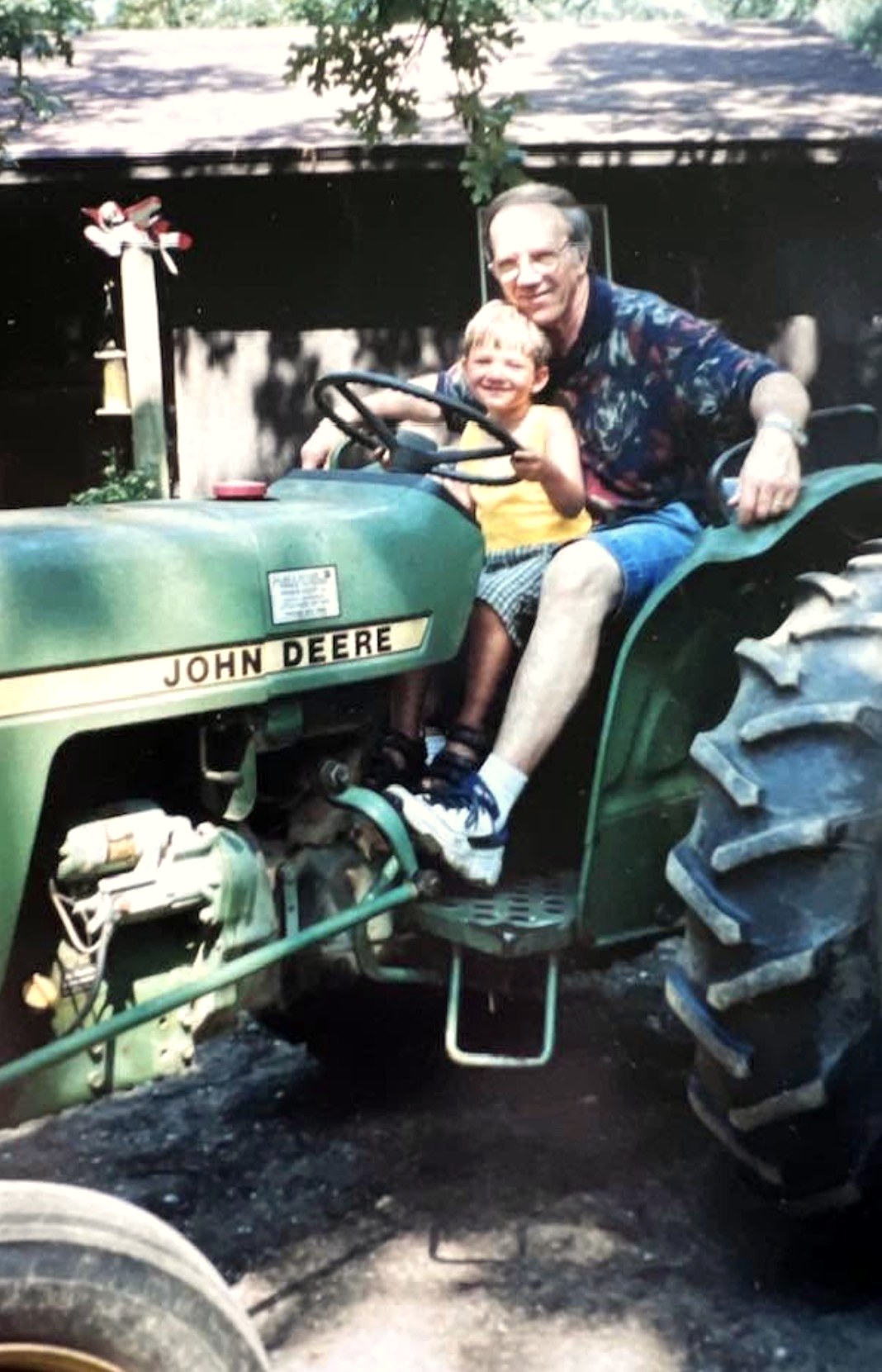 Granddad Bill and Cade on the John Deere tractor, archival family farm photo